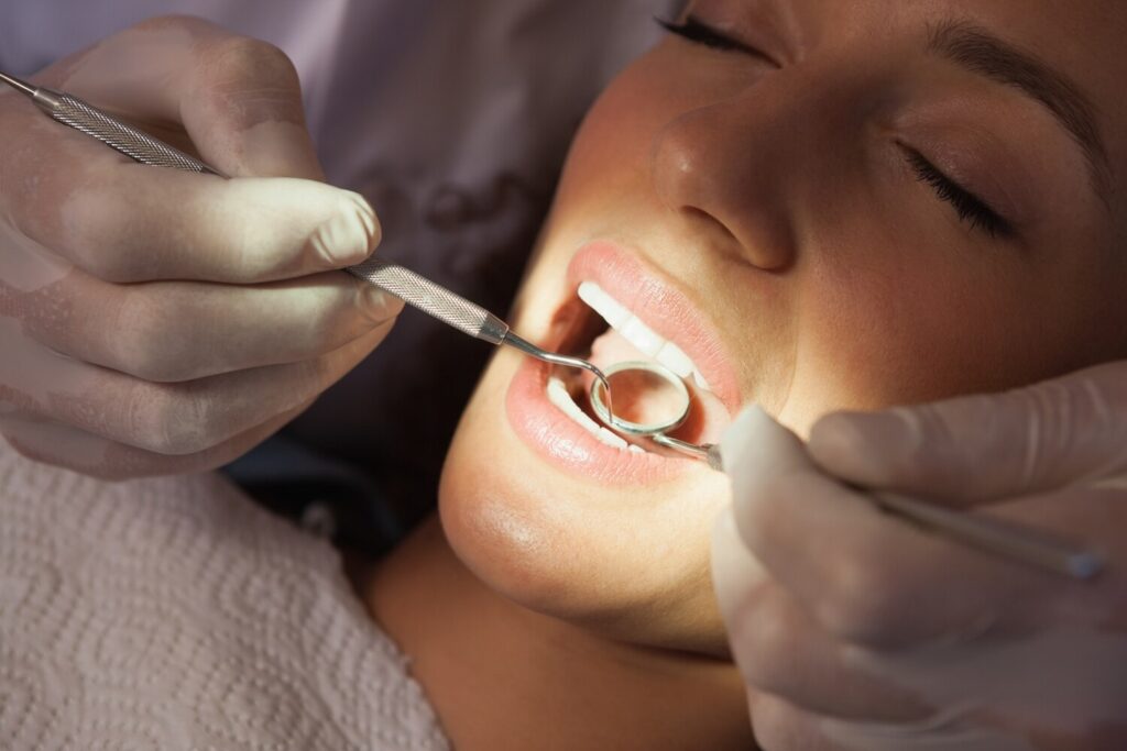 Dentist examining patients teeth dentists chair 13339 50664 Dentist examining patients teeth dentists chair 13339 50664