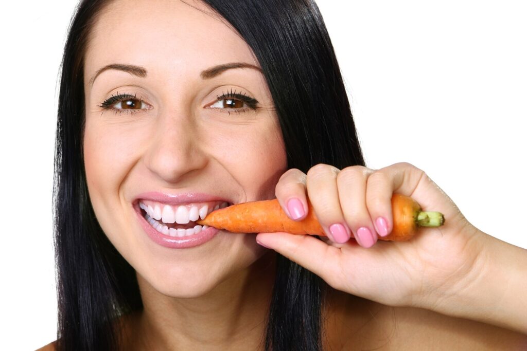 Young woman eating carrot white 114309 1139 Young woman eating carrot white 114309 1139